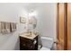 Powder room featuring a single sink vanity, wood cabinet, and a standard toilet at 2908 Bolo Trl, Raleigh, NC 27615