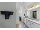 Bright bathroom features granite countertops, white cabinetry and a large framed mirror above the vanity at 2908 Bolo Trl, Raleigh, NC 27615