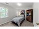 Cozy bedroom featuring a full size bed, carpeting, and a wooden bookshelf at 2908 Bolo Trl, Raleigh, NC 27615
