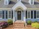 Inviting front entrance with a black door, brick steps, and lovely landscaping at 2908 Bolo Trl, Raleigh, NC 27615