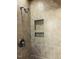Tiled shower stall featuring a shower head and built-in shelves at 2908 Bolo Trl, Raleigh, NC 27615