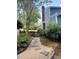 Charming side yard featuring a stone walkway, wooden gate, and lush landscaping, adding to the home's curb appeal at 2908 Bolo Trl, Raleigh, NC 27615