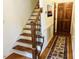 Classic staircase design with wooden banister and carpeted steps provides an elegant transition between floors at 2908 Bolo Trl, Raleigh, NC 27615