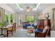Inviting sunroom with skylights, hardwood floors, and comfortable wicker furniture at 2908 Bolo Trl, Raleigh, NC 27615