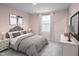 Cozy bedroom features neutral tones, comfortable bedding, bedside tables and a large window for natural light at 294 N Coral Bells Way, Four Oaks, NC 27524