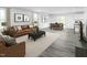 Open-concept living room featuring stylish furniture and natural light at 294 N Coral Bells Way, Four Oaks, NC 27524