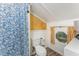 Compact bathroom with a shower featuring a decorative curtain and white walls at 300 Rabbit Run, Pittsboro, NC 27312
