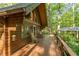 Expansive wooden deck features rocking chairs and overlooks lush greenery at 300 Rabbit Run, Pittsboro, NC 27312
