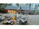 Cozy cabin exterior features an inviting firepit with Adirondack chairs for outdoor relaxation and gathering at 300 Rabbit Run, Pittsboro, NC 27312