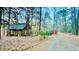 Cozy exterior of log cabin with surrounding lush forest at 300 Rabbit Run, Pittsboro, NC 27312