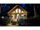 Charming cabin exterior illuminated at night, emphasizing cozy, inviting ambiance at 300 Rabbit Run, Pittsboro, NC 27312