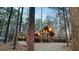 Exterior cabin view with string lights through forest setting at 300 Rabbit Run, Pittsboro, NC 27312