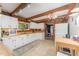 Country kitchen with tile floor features white cabinetry, an undermount sink and wooden countertops at 300 Rabbit Run, Pittsboro, NC 27312