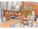 Open-concept living room featuring wood walls, vaulted ceiling, and an abundance of natural light at 300 Rabbit Run, Pittsboro, NC 27312