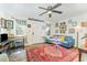 Bright living room showcasing a comfortable sofa, accent rug, and natural light from the windows at 300 Rabbit Run, Pittsboro, NC 27312