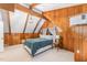 Cozy bedroom with wood-paneled walls, carpet floor and exposed ceiling beams at 300 Rabbit Run, Pittsboro, NC 27312