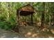 Outdoor pavilion with picnic tables surrounded by mature trees at 300 Rabbit Run, Pittsboro, NC 27312