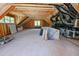 Unfinished attic space with wood beams, exposed HVAC ductwork, and natural light from windows at 3004 Eden Harbor Ct, Raleigh, NC 27613
