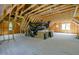 Spacious unfinished attic with exposed wood beams and black HVAC ductwork at 3004 Eden Harbor Ct, Raleigh, NC 27613
