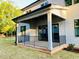 Covered back porch with black railings, ceiling fan, and sliding glass doors overlooking a well-maintained backyard at 3004 Eden Harbor Ct, Raleigh, NC 27613