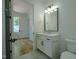 Bathroom featuring a single sink vanity, tile floors, and an open doorway to the bedroom at 3004 Eden Harbor Ct, Raleigh, NC 27613