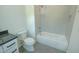 Bright bathroom with a white bathtub and shower combo, toilet, and single sink vanity at 3004 Eden Harbor Ct, Raleigh, NC 27613