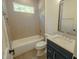 Cozy bathroom featuring a bathtub with shower, toilet, and single-sink vanity with dark cabinets at 3004 Eden Harbor Ct, Raleigh, NC 27613