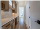 Butler's pantry with custom cabinetry, marble backsplash, and ample counter space at 3004 Eden Harbor Ct, Raleigh, NC 27613