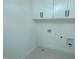 Laundry room featuring upper white cabinets with black hardware and gray tile flooring at 3004 Eden Harbor Ct, Raleigh, NC 27613