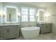 Luxurious main bathroom with a soaking tub, double vanities, and marble flooring at 3004 Eden Harbor Ct, Raleigh, NC 27613