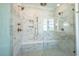 Elegant bathroom with a frameless glass shower featuring marble-style tile and a built-in bench at 3004 Eden Harbor Ct, Raleigh, NC 27613