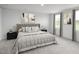 Inviting main bedroom featuring a comfortable bed, neutral decor and natural lighting at 302 N Coral Bells Way, Four Oaks, NC 27524