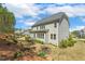 Beautiful backyard featuring a two-story home, lush landscaping, and a deck at 304 Channel Cove Dr, Holly Springs, NC 27540