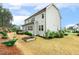 The spacious backyard features a two-story home with a manicured lawn and a deck at 304 Channel Cove Dr, Holly Springs, NC 27540