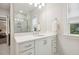 Bright bathroom with a marble shower, white vanity, and natural light from the window at 304 Channel Cove Dr, Holly Springs, NC 27540