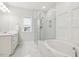 Bathroom with walk-in shower, soaking tub, and marble design at 304 Channel Cove Dr, Holly Springs, NC 27540