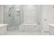 Bathroom with walk-in shower, soaking tub, and marble design at 304 Channel Cove Dr, Holly Springs, NC 27540
