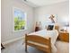 Bright bedroom with a twin bed, wooden ladder, and a window overlooking the backyard at 304 Channel Cove Dr, Holly Springs, NC 27540