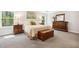 Bedroom featuring large windows, soft carpet, and a wooden chest at 304 Channel Cove Dr, Holly Springs, NC 27540