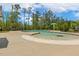View of the large community swimming pool with a splash zone and nearby trees at 304 Channel Cove Dr, Holly Springs, NC 27540