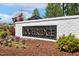 Elegant community entrance sign with blooming flowers and lush landscaping at 304 Channel Cove Dr, Holly Springs, NC 27540