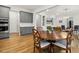 Elegant dining room features a round wooden table, decorative chairs, and views into the living area at 304 Channel Cove Dr, Holly Springs, NC 27540