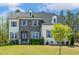Charming two-story home featuring a mix of stone and painted brick and a well-manicured lawn at 304 Channel Cove Dr, Holly Springs, NC 27540
