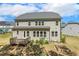 Rear exterior of a two-story home featuring a wood deck and backyard at 304 Channel Cove Dr, Holly Springs, NC 27540