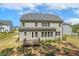 Back exterior view of home showcasing deck, windows, backyard, and landscaping at 304 Channel Cove Dr, Holly Springs, NC 27540