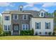 Charming two-story home featuring a mix of stone and painted brick and a well-manicured lawn at 304 Channel Cove Dr, Holly Springs, NC 27540