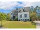 Attractive home with manicured lawn, combination stone and painted brick, and mature trees at 304 Channel Cove Dr, Holly Springs, NC 27540