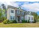 Attractive home with manicured lawn, combination stone and painted brick, and mature trees at 304 Channel Cove Dr, Holly Springs, NC 27540