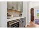 Close-up of the built-in gray cabinets and mini-fridge in hallway at 304 Channel Cove Dr, Holly Springs, NC 27540