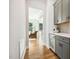 Hallway with wine storage, gray cabinets, and a view of the living room at 304 Channel Cove Dr, Holly Springs, NC 27540